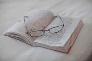 a pair of glasses sitting on top of a book at Komiza Provita Guesthouse in Komiža