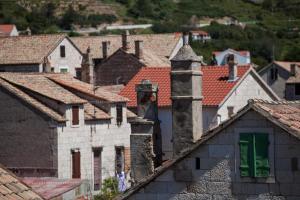a group of roofs of houses in a town at Komiza Provita Guesthouse in Komiža