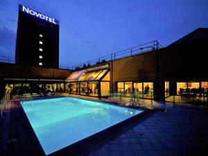 a large swimming pool in front of a large building at Novotel Milano Linate Aeroporto in Milan