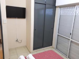 a bathroom with a shower with a tv and a shower at Depto. Centrico in Corrientes