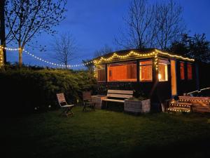 a tiny house with lights on it in the yard at The Cabin Project in Portglenone