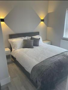 a bedroom with a large bed with two night stands at Apt 3, Lisvarna House in Buncrana