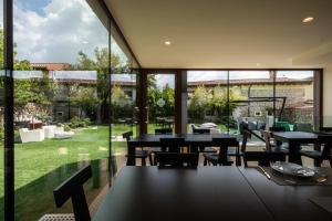 a restaurant with tables and chairs and a large window at La Locanda Del Grop in Tavagnacco