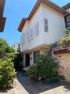 una casa bianca con delle piante davanti di Villa ANATOLIAN a Antalya (Adalia)