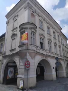 a building with a flag on the side of it at Apartmány Šitavanc in Příbor