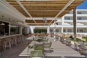 an outdoor patio with tables and chairs and a building at Can Salia in San Antonio Bay