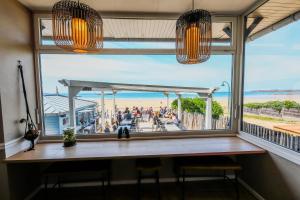 a window in a room with a view of the beach at Hôtel Les Charmettes - Saint Malo in Saint Malo +56 photos