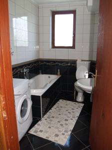 a bathroom with a tub and a toilet and a sink at Jelena in Korenica +58 photos