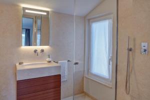 a bathroom with a sink and a glass shower at Il Leccio - Luxury Resort Portofino Monte in Santa Margherita Ligure