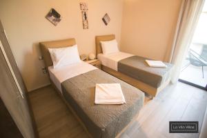 Postel nebo postele na pokoji v ubytování La Vita Villas