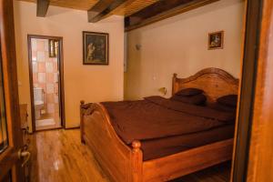 a bedroom with a wooden bed in a room at Vila Izvoarele in Izvoarele +33 photos