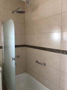 a bathroom with a shower with a bath tub at Edificio Soles in Puerto Madryn