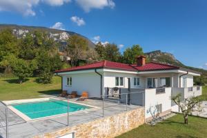 a villa with a swimming pool and a house at Villa Vitovlje in Vitovlje