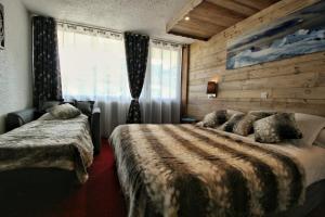 Postel nebo postele na pokoji v ubytování Hotel Le Pelvoux
