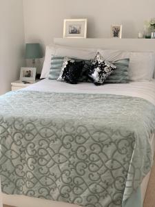 a white bed with pillows on top of it at Stanton Cross 5 persons 3 Bed Home in Wellingborough