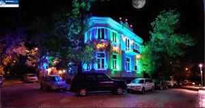 a lit up building with blue and green lights at Rimini Club Inn & Suites in Shumen