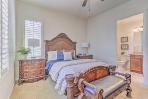 1 dormitorio con cama grande de madera y banco en Desert Views and Pool Access Home in La Quinta!, en La Quinta 26 fotos más
