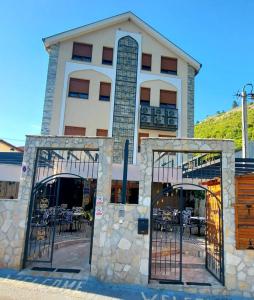 a large building with gates in front of it at Hotel Blagaj Mostar in Blagaj