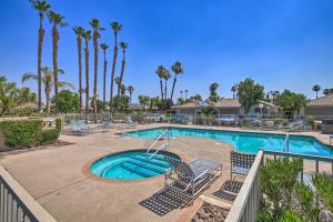 a swimming pool with lounge chairs and a resort at Luxe Palm Desert Retreat with Private Outdoor Oasis! in Palm Desert