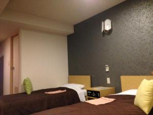 Postel nebo postele na pokoji v ubytování Nagano Plaza Hotel