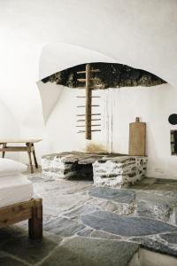 a room with a fireplace with a cross on the wall at Hotel Weiss Kreuz in Splügen