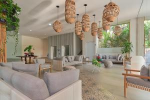 a living room with lots of furniture and chandeliers at Maxwell Residences at Indah in Puerto Vallarta