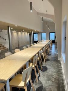 a long row of tables and chairs in a room at Casa Galego in Fonfría