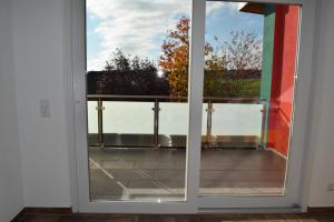 uma porta de vidro deslizante com vista para uma varanda em Ferienhaus 1 em Göbenhausen
