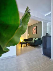 a living room with a couch and a green plant at The Tree in Skiathos Town