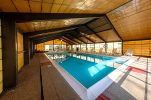 a large swimming pool in a building at Red Roof Inn & Suites Newburgh - Stewart Airport in New Windsor