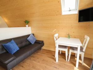 a living room with a couch and a table at Seren in Llandrindod Wells
