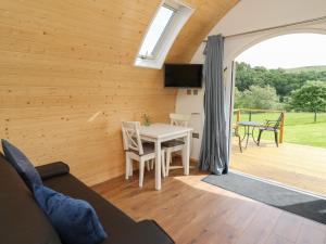a living room with a table and a patio at Seren in Llandrindod Wells