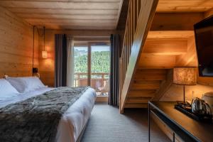 Postel nebo postele na pokoji v ubytování Le Chalet Blanc Hôtel & Spa