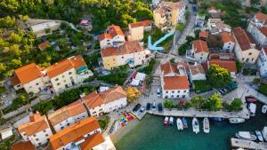 an aerial view of a town with boats in the water at Room Dinko in Valun