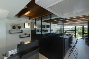 a kitchen with black cabinets and a counter top at Radici Luxury B&B in Monsampolo del Tronto
