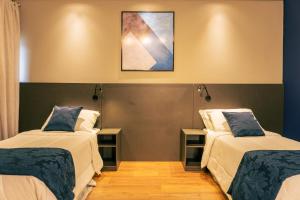 Postel nebo postele na pokoji v ubytování Mayná Hotel Prudentópolis Centro