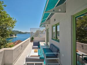 a balcony with benches and a view of the water at The Tree Suites in Skiathos
