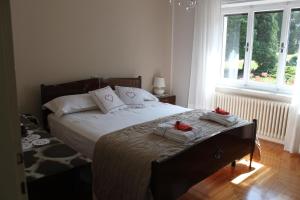 a bedroom with a bed with towels on it at Villa Anna in Domegge di Cadore