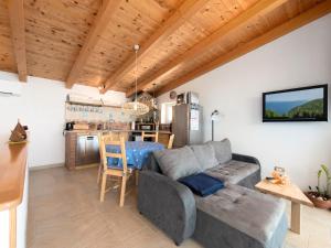 a living room with a couch and a table at Ferienhaus Baraka - Medveja in Lovran