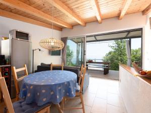 a kitchen and dining room with a blue table and chairs at Ferienhaus Baraka - Medveja in Lovran +19 photos