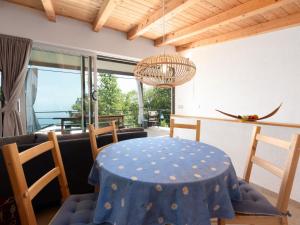 a dining room with a blue table and chairs at Ferienhaus Baraka - Medveja in Lovran