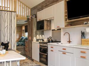 a kitchen with white cabinets and a sink at Jacob's Meadow Pod 2 in Shrewsbury