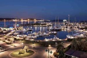 a marina at night with boats in the water at Sa Marinedda Guest Apartment - self check-in - IUN R1644 in Olbia