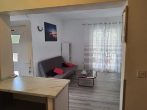 a living room with a couch and a living room with a table at Apartments Laura in Hvar