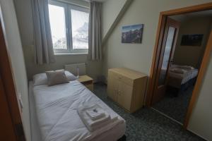 Posteľ alebo postele v izbe v ubytovaní Penzion Rysy