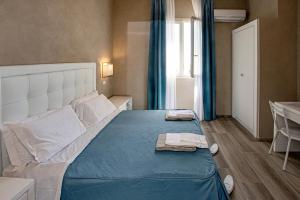 Postel nebo postele na pokoji v ubytování Hotel Cecina Beach
