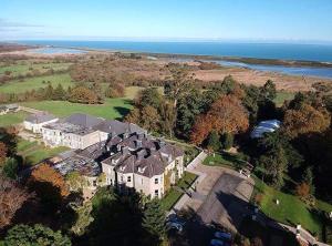 an aerial view of a large house with the ocean at Tinakilly Country House Hotel in Rathnew