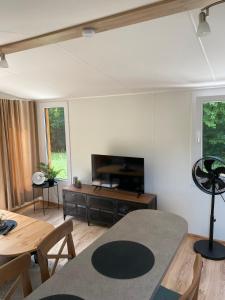 a living room with a television and a table at Mobile House Bojnice in Bojnice