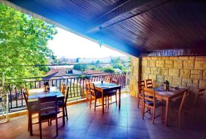 a patio with tables and chairs on a balcony at Casa Laura in Mangalia