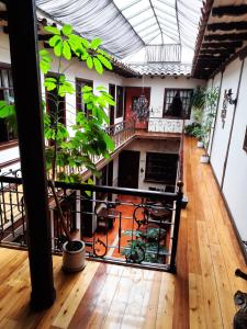 an empty room with a balcony with a plant at La Posada Cuencana Hotel in Cuenca